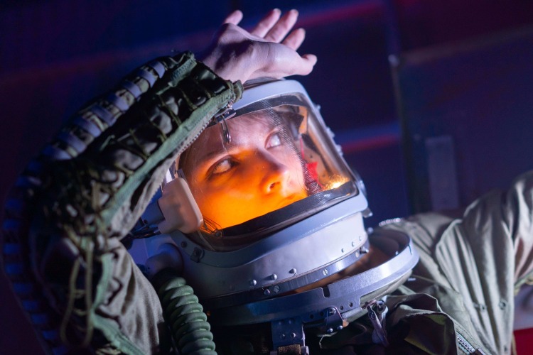 woman astronaut staring into light