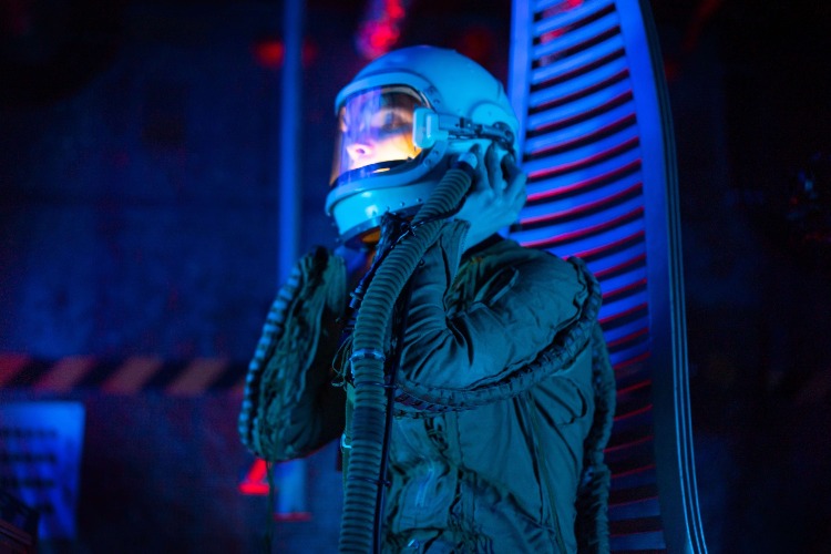 woman astronaut holding helmet